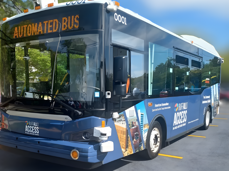 The image shows a picture of the blue All Access Loop shuttle. It is a blue bus that is parked. It's sign at the front says "Automated Bus." The All Access logo is on the front of the bus beneath the windshield.